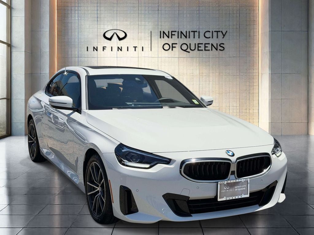 2025 BMW 2 Series 230i xDrive in Alpine White — front three-quarter view